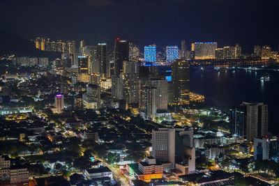 High angle view of illuminated city lit up at night