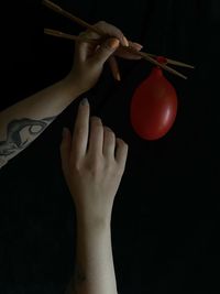 Cropped hands of woman holding apple