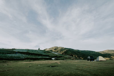 Scenic view of agricultural field against sky