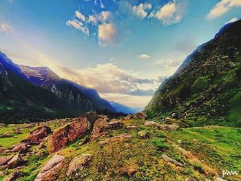 Scenic view of mountains against cloudy sky