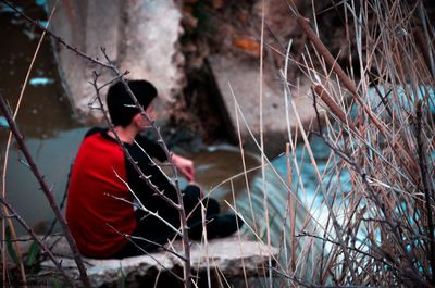 Man wearing sunglasses sitting outdoors