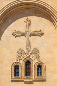 Low angle view of cross pattern on church wall