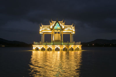 View of castle in lake at night