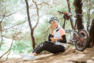 Smiling woman listening music at park