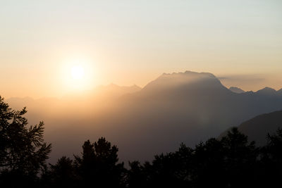 Scenic view of silhouette mountains against sky at sunset