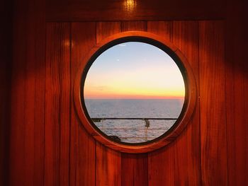 Scenic view of sea against sky seen through window