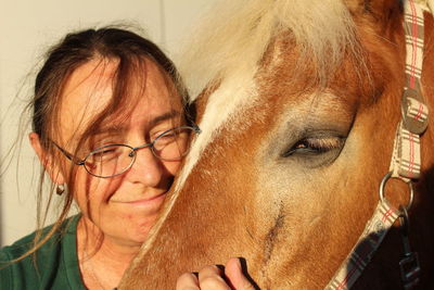 Close-up of woman petting horse