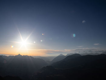 Scenic view of silhouette mountains against sky at sunset