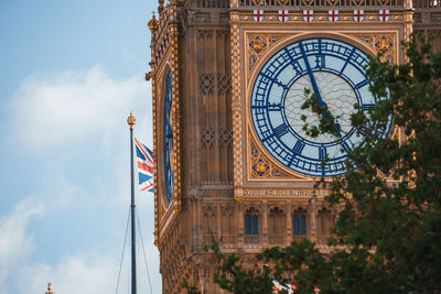 Low angle view of clock tower against sky