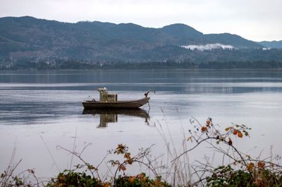 Boat in lake against sky