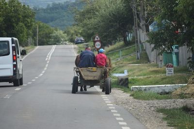 Rear view of people on horse cart