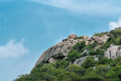 Low angle view of rock formation against sky