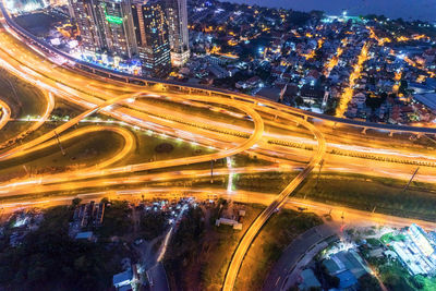 High angle view of illuminated roads and bridges in city at night