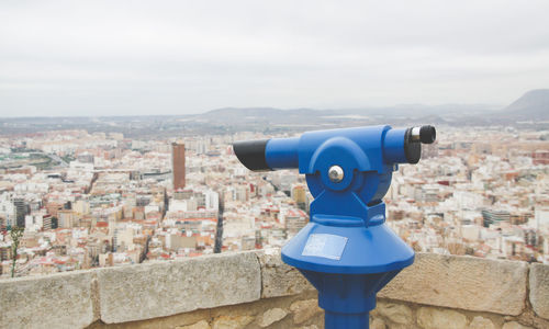 View of cityscape against cloudy sky