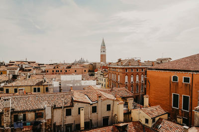 Buildings in town against sky