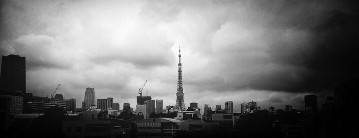 Cityscape against cloudy sky