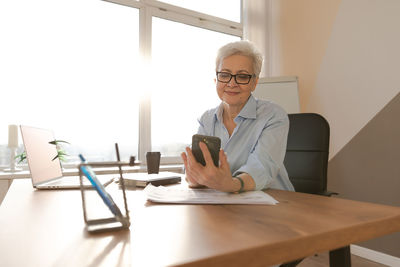 Portrait of businessman working at desk in office