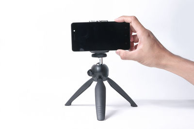 Low angle view of person photographing against white background