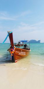 Boat moored in calm blue sea