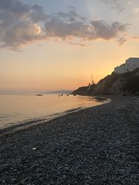 Scenic view of beach against sky during sunset