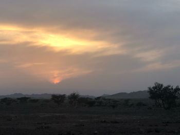 Scenic view of field against sky during sunset