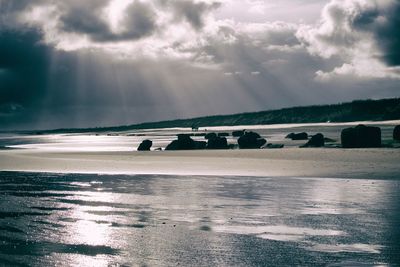 Scenic view of sea against cloudy sky