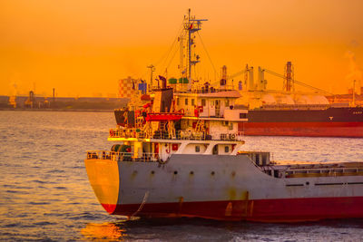 Ship in sea against sky during sunset