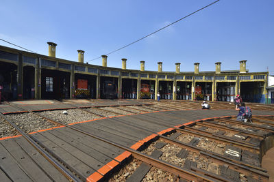 Railroad tracks against clear blue sky