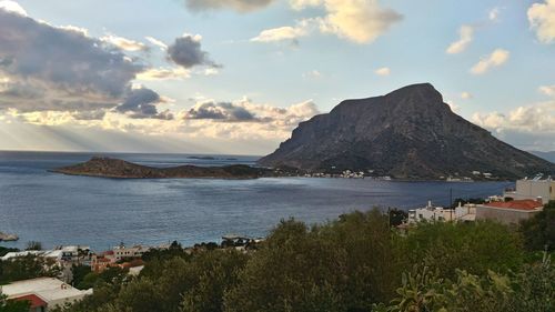 Scenic view of sea and mountains against sky