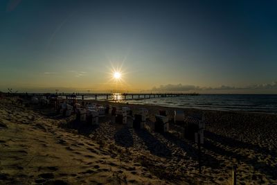 Scenic view of beach against sky during sunset