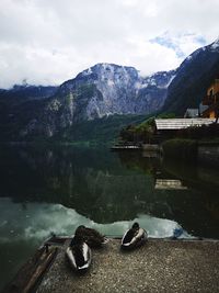 Scenic view of lake by mountains against sky