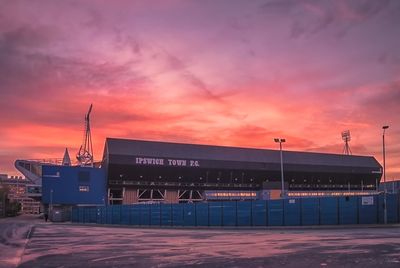 View of building against cloudy sky during sunset