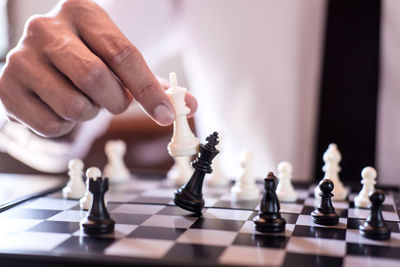 Midsection of man playing chess