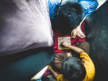 2 kids having fun playing snakes and ladders