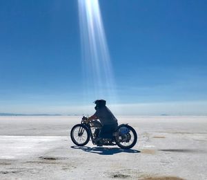 Man riding bicycle on sunny day