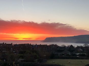 Scenic view of townscape against sky during sunset