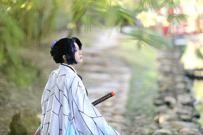 Portrait of young woman looking away