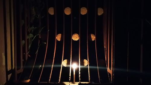 Low angle view of illuminated lights hanging at night