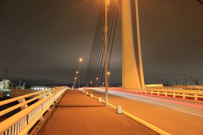 Light trails on road against sky at night