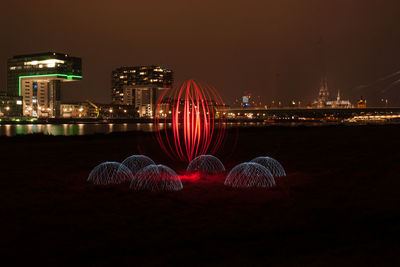 Illuminated ferris wheel at night