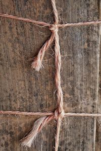 Close-up of tied rope on wood