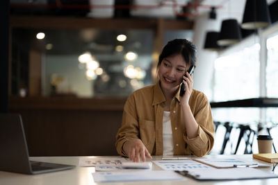 Smiling businesswoman working at office