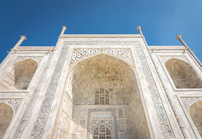 Low angle view of historical building against blue sky