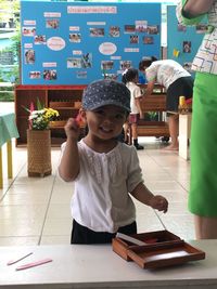 Portrait of cute girl standing in kindergarten