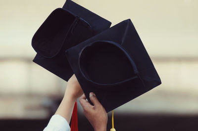 Close-up of people holding mortarboards