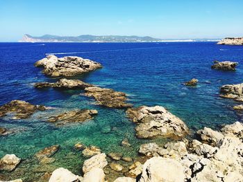 Scenic view of sea against blue sky