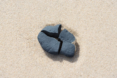 High angle view of broken rock on sand