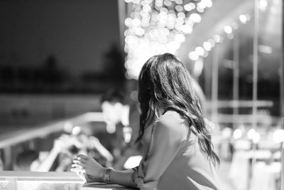 Side view of woman sitting in restaurant