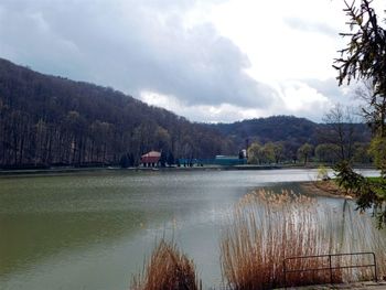 Scenic view of lake against cloudy sky