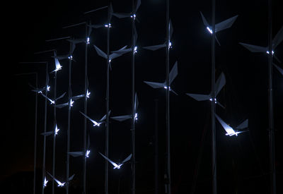 Low angle view of illuminated light at night outdoors